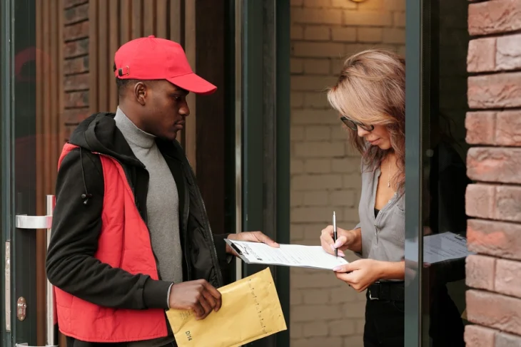 woman signing for document